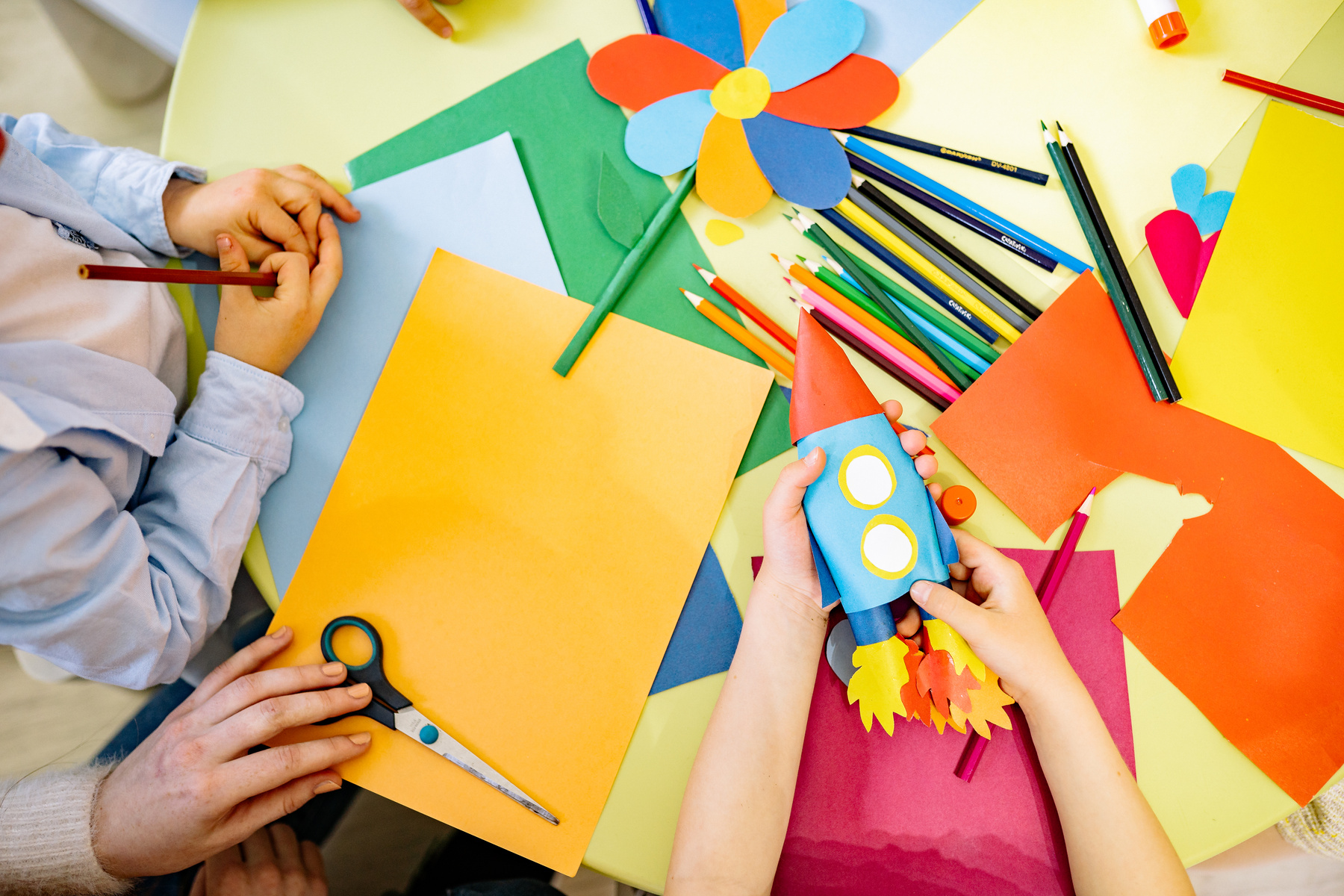 Person Holding Yellow Paper With Blue Eyes